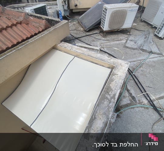 סוכך לבן מותקן על גג עם רעפים אדומים